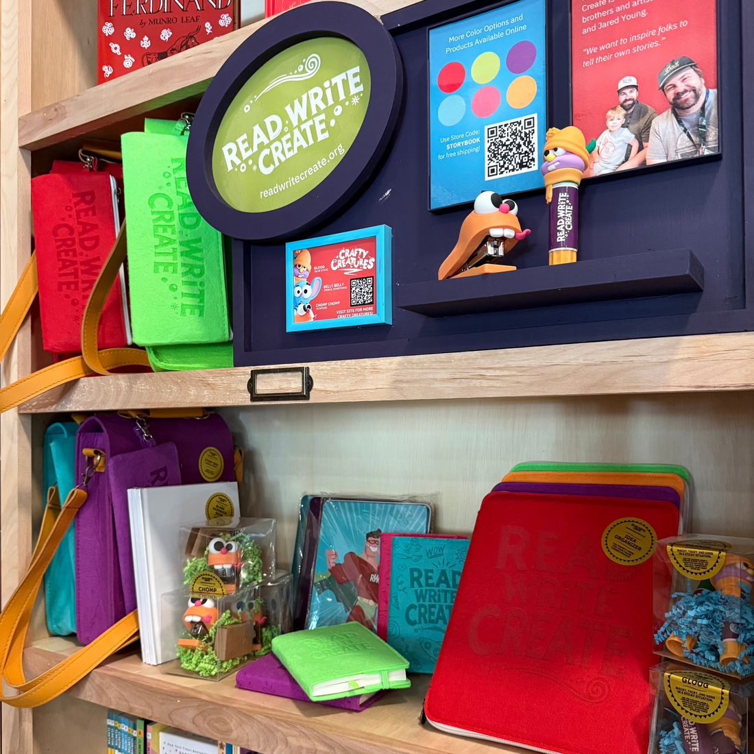 Shelf with educational materials including books, a tablet, and stationery items.